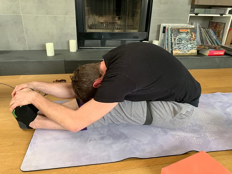 Man doing Seated Forward Bend Caterpillar Yin Yoga pose (Paschimottanasana)for yoga for shoulder pain. Kevin Parenteau Yin Yoga