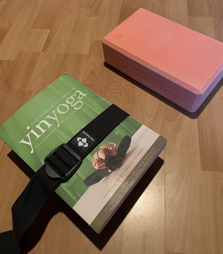 shows a stack of books bound together as a DIY Yoga Block